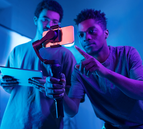 two youths with smartphone filming